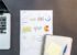 Desk with business charts, laptop and notebooks