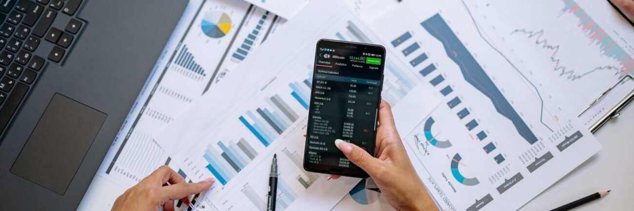 Charts and smartphone used for data analysis Charts and smartphone used for data analysis
